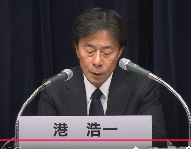 港浩一氏の記者会見での説明姿